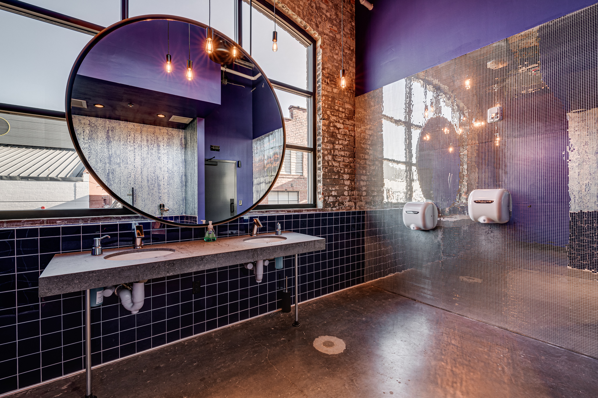 Resident Culture bathrooms with large mirror in front of windows